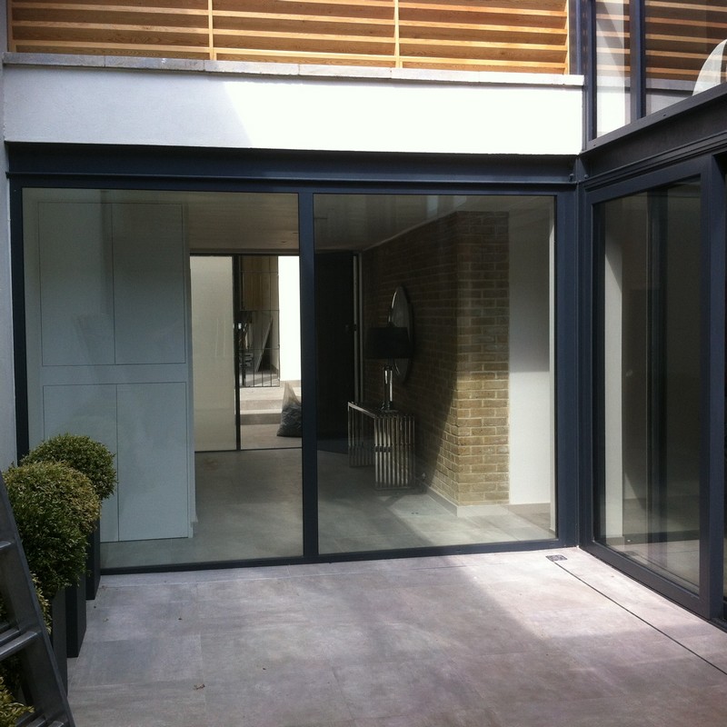 Floor-to-ceiling sliding doors opening to courtyard in Potters Bar