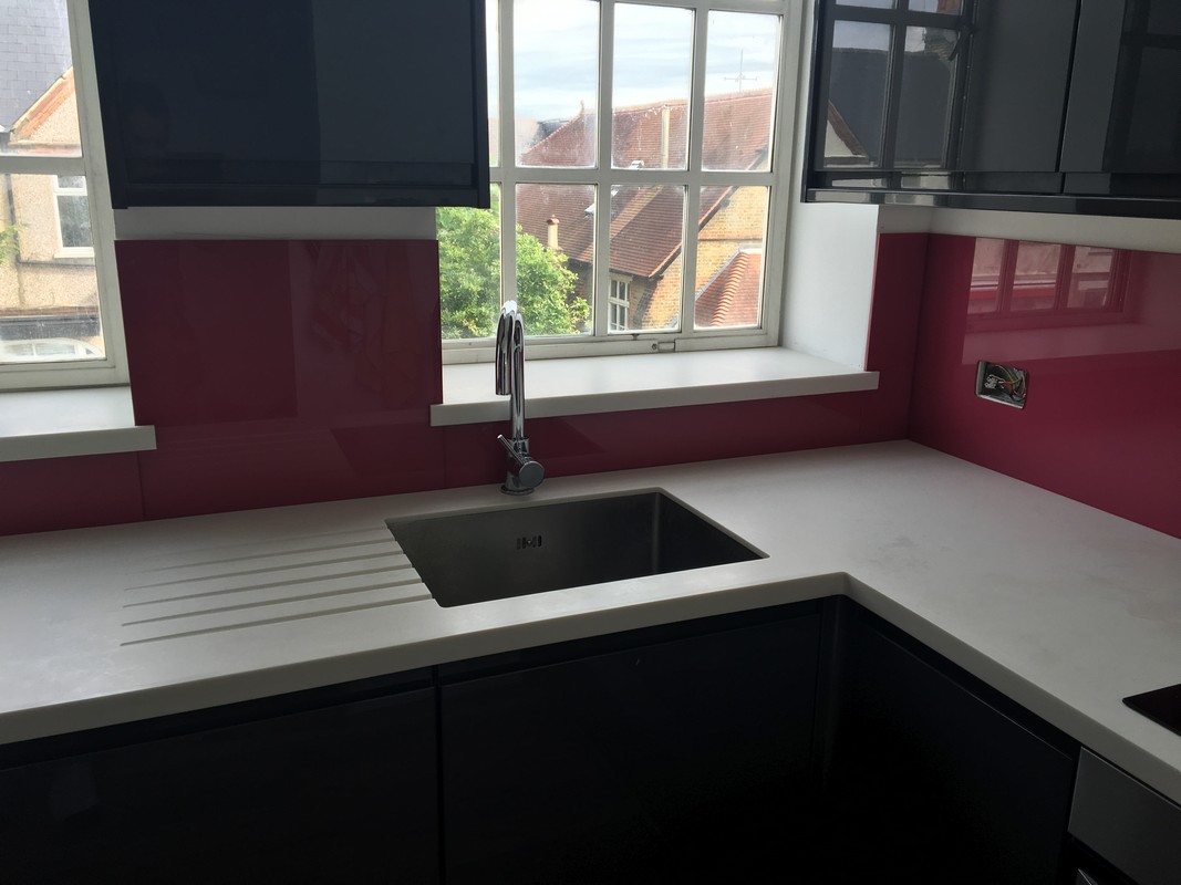 Deep plum coloured glass splashback in modern Potters Bar kitchen